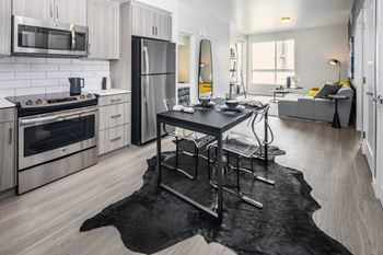 A kitchen with stainless steel appliances and a table